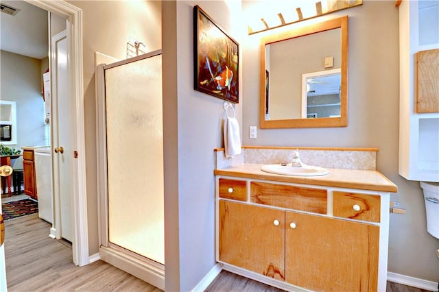 811 E Township St, Fayetteville, AR 72703 - full bath with a shower stall, wood finished floors, and vanity