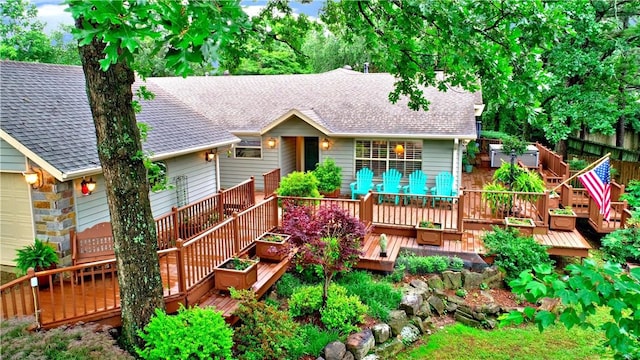811 E Township St, Fayetteville, AR 72703 - view of front of home featuring roof with shingles, a deck, and a garage