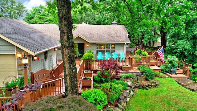 811 E Township St, Fayetteville, AR 72703 - view of front facade featuring a shingled roof, a wooden deck, a front yard, and an attached garage