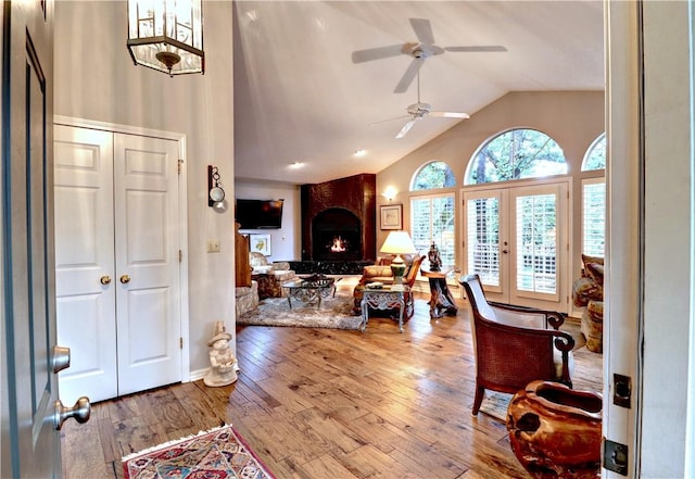 811 E Township St, Fayetteville, AR 72703 - living room with high vaulted ceiling, ceiling fan, wood-type flooring, a fireplace, and baseboards