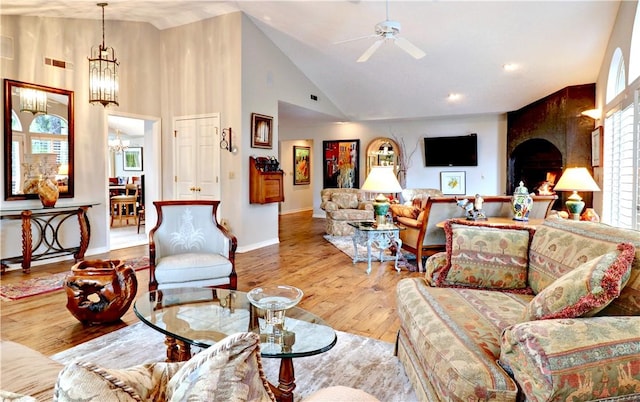 811 E Township St, Fayetteville, AR 72703 - living area featuring ceiling fan, hardwood / wood-style floors, a chandelier, high vaulted ceiling, and baseboards