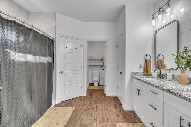 1461 Colonel Mcneil Dr, Prairie Grove, AR 72753 - full bathroom with vanity, wood finished floors, curtained shower, toilet, and baseboards