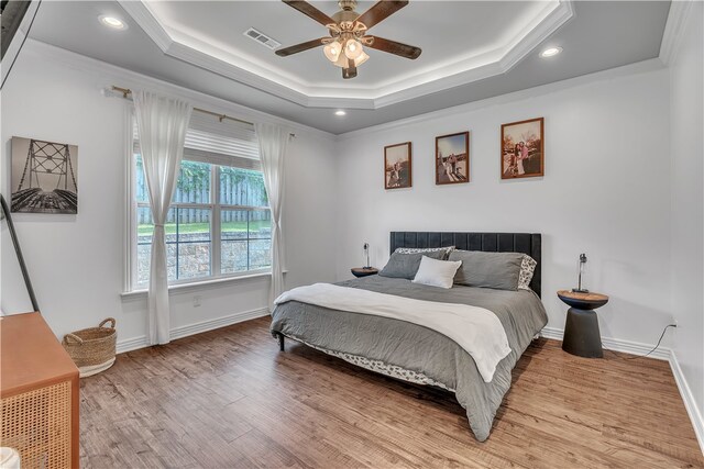 1461 Colonel Mcneil Dr, Prairie Grove, AR 72753 - bedroom with wood finished floors, crown molding, baseboards, a raised ceiling, and recessed lighting