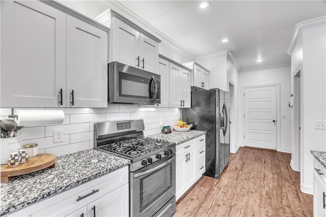 1461 Colonel Mcneil Dr, Prairie Grove, AR 72753 - kitchen featuring stainless steel appliances, crown molding, backsplash, light stone countertops, and recessed lighting