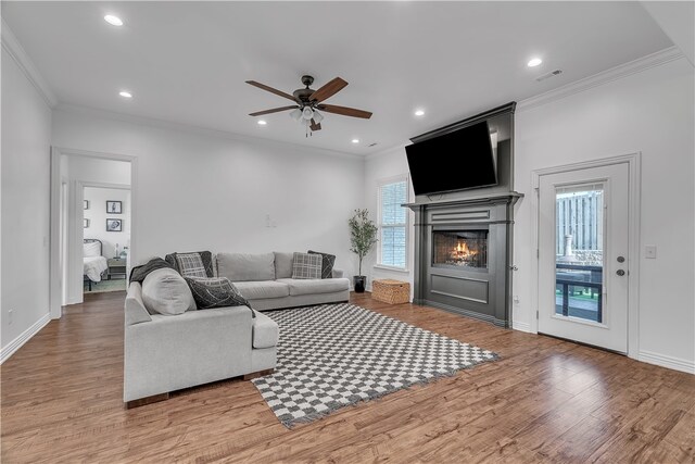 1461 Colonel Mcneil Dr, Prairie Grove, AR 72753 - living area featuring ornamental molding, ceiling fan, wood finished floors, a lit fireplace, and recessed lighting