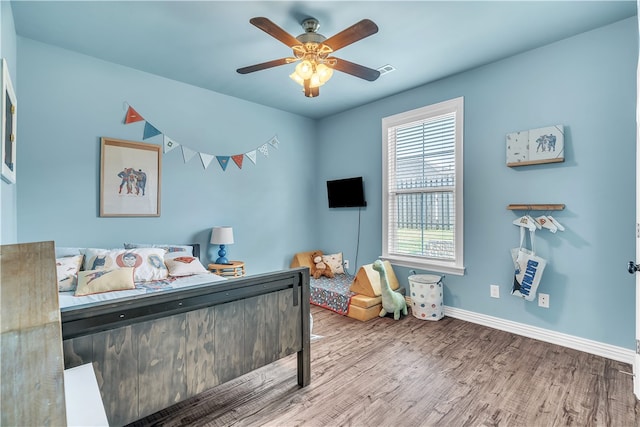 1461 Colonel Mcneil Dr, Prairie Grove, AR 72753 - bedroom with wood finished floors, multiple windows, baseboards, and ceiling fan
