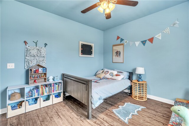 1461 Colonel Mcneil Dr, Prairie Grove, AR 72753 - bedroom with baseboards, wood finished floors, and a ceiling fan