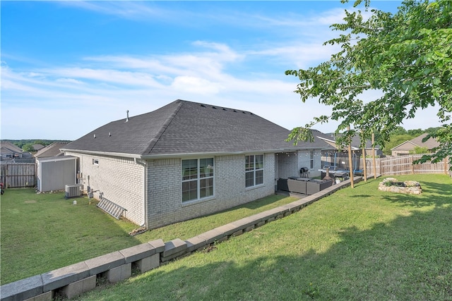 1461 Colonel Mcneil Dr, Prairie Grove, AR 72753 - rear view of house featuring brick siding, a shingled roof, central AC, and an outdoor living space