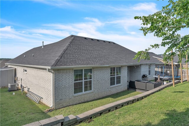 1461 Colonel Mcneil Dr, Prairie Grove, AR 72753 - rear view of property with a shingled roof, brick siding, a yard, a patio, and central air condition unit