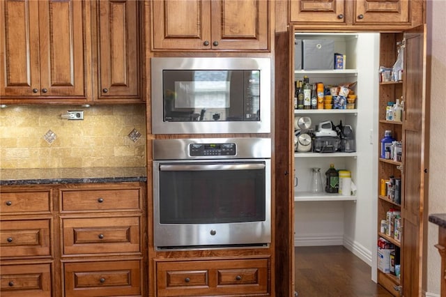 3504 NW Edgewood Ave, Bentonville, AR 72712 - kitchen with oven, built in microwave, and brown cabinets