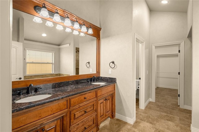 3504 NW Edgewood Ave, Bentonville, AR 72712 - bathroom featuring double vanity, baseboards, and recessed lighting