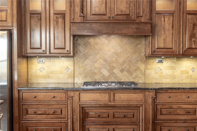3504 NW Edgewood Ave, Bentonville, AR 72712 - kitchen with appliances with stainless steel finishes, backsplash, dark stone countertops, and brown cabinetry