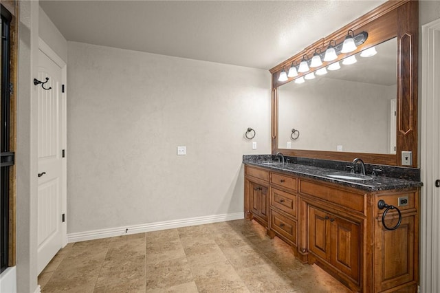 3504 NW Edgewood Ave, Bentonville, AR 72712 - bathroom with double vanity, baseboards, and stone finish flooring