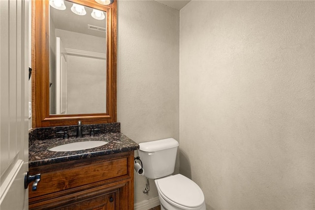 3504 NW Edgewood Ave, Bentonville, AR 72712 - bathroom with toilet, vanity, a textured wall, and baseboards