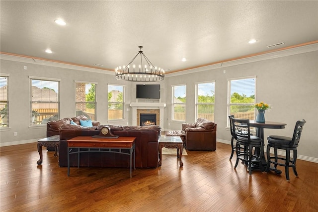 3504 NW Edgewood Ave, Bentonville, AR 72712 - living room featuring baseboards, wood finished floors, ornamental molding, a lit fireplace, and recessed lighting