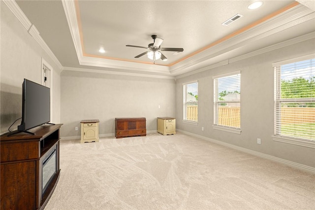 3504 NW Edgewood Ave, Bentonville, AR 72712 - unfurnished living room featuring ornamental molding, a raised ceiling, plenty of natural light, a ceiling fan, and light carpet