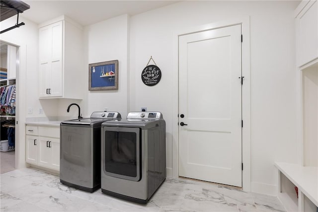 301 SW Autumn Hills Rd, Bentonville, AR 72712 - laundry area with light marble finish flooring, washing machine and clothes dryer, and cabinet space