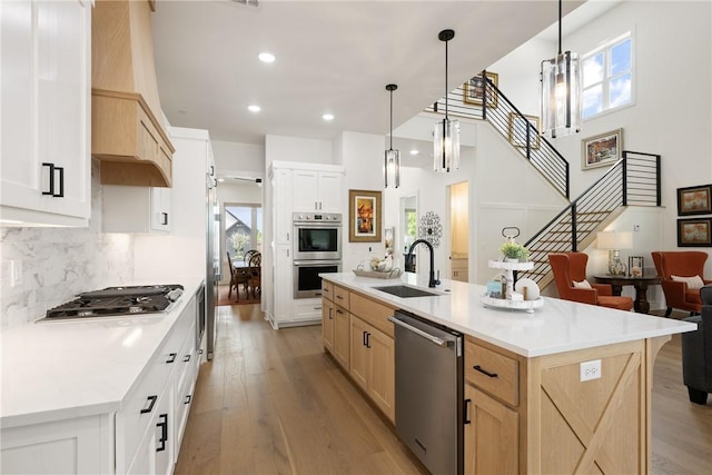 301 SW Autumn Hills Rd, Bentonville, AR 72712 - kitchen featuring appliances with stainless steel finishes, a sink, light brown cabinetry, healthy amount of natural light, and recessed lighting