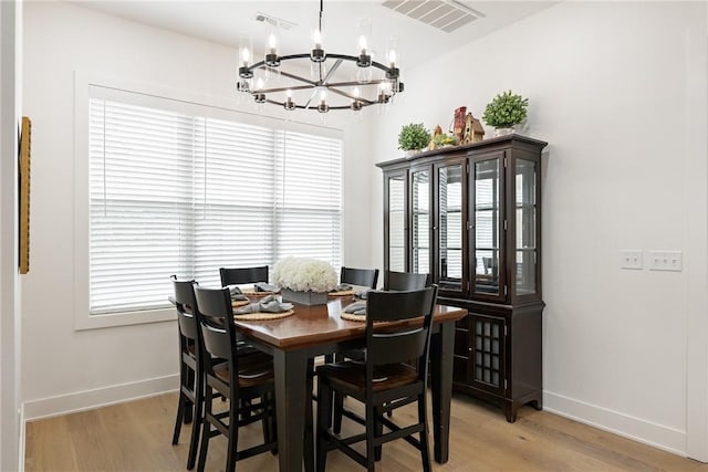 301 SW Autumn Hills Rd, Bentonville, AR 72712 - dining area with a chandelier, light wood-style flooring, and baseboards