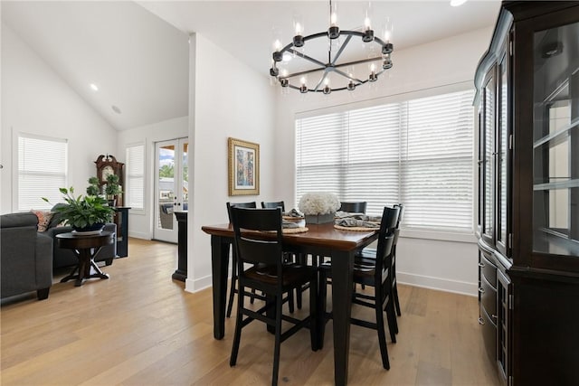 301 SW Autumn Hills Rd, Bentonville, AR 72712 - dining room with a chandelier, light wood-style floors, baseboards, and high vaulted ceiling
