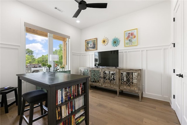 301 SW Autumn Hills Rd, Bentonville, AR 72712 - dining room with a decorative wall, a ceiling fan, light wood-style floors, a wainscoted wall, and recessed lighting