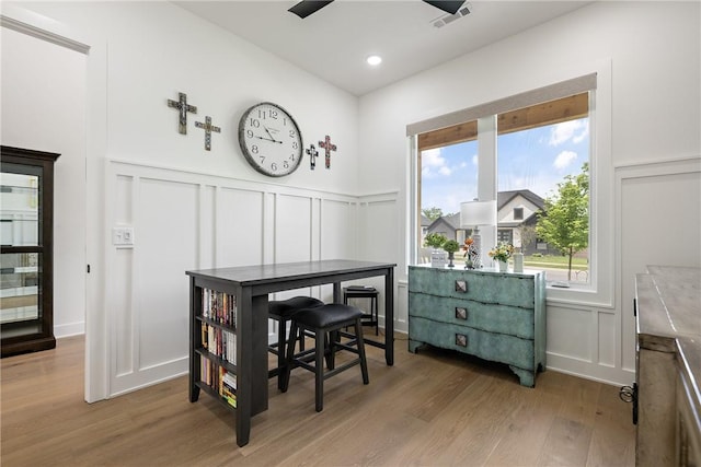 301 SW Autumn Hills Rd, Bentonville, AR 72712 - dining area with a decorative wall, light wood-type flooring, and a wainscoted wall