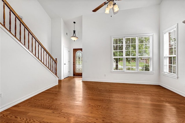 4801 SW Golden Eagle Ave, Bentonville, AR 72713 - foyer entrance with stairway, wood finished floors, high vaulted ceiling, ceiling fan, and baseboards