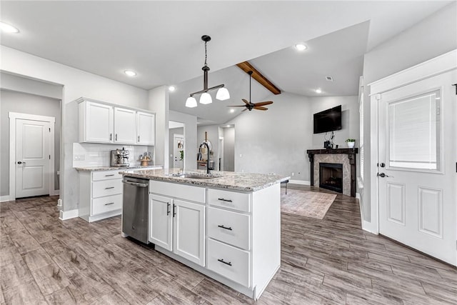 1140 Durante St, Tontitown, AR 72762 - kitchen featuring dishwasher, a sink, a fireplace, open floor plan, and baseboards