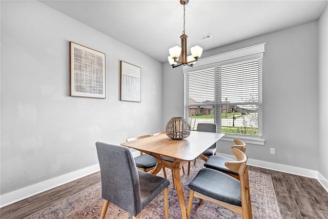 1140 Durante St, Tontitown, AR 72762 - dining area with a chandelier, baseboards, and dark wood finished floors