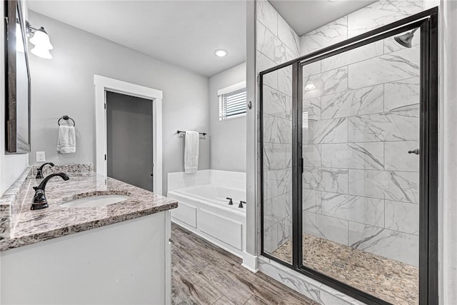 1140 Durante St, Tontitown, AR 72762 - bathroom with a garden tub, a shower stall, double vanity, wood finished floors, and recessed lighting