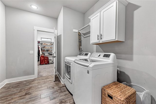 1140 Durante St, Tontitown, AR 72762 - washroom with separate washer and dryer, cabinet space, wood finished floors, baseboards, and recessed lighting