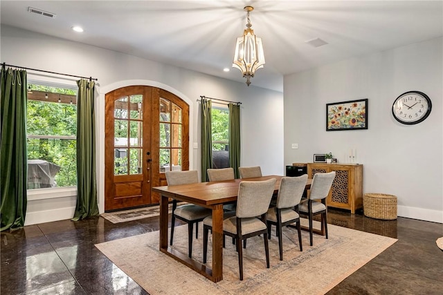 112 E Woodside Ln, Rogers, AR 72756 - dining area featuring arched walkways, plenty of natural light, a chandelier, baseboards, and recessed lighting