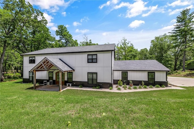 112 E Woodside Ln, Rogers, AR 72756 - rear view of house featuring a lawn and a shingled roof
