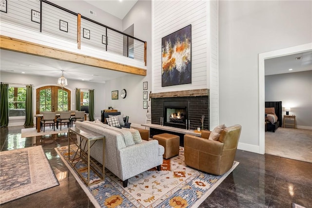 112 E Woodside Ln, Rogers, AR 72756 - living room featuring a towering ceiling, a brick fireplace, and baseboards