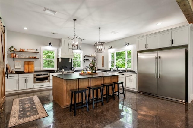 112 E Woodside Ln, Rogers, AR 72756 - kitchen featuring appliances with stainless steel finishes, open shelves, custom range hood, dark countertops, and recessed lighting