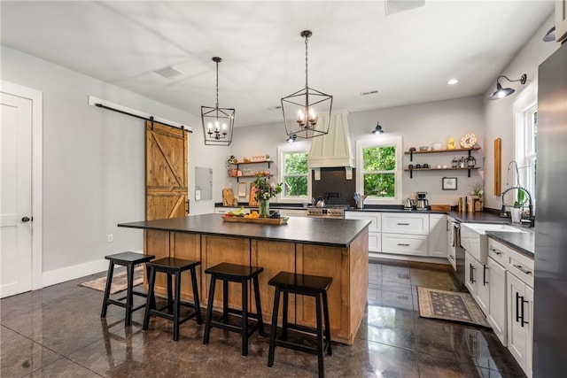 112 E Woodside Ln, Rogers, AR 72756 - kitchen featuring open shelves, dark countertops, premium range hood, a barn door, and recessed lighting
