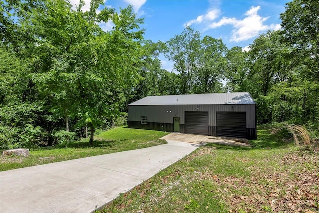 112 E Woodside Ln, Rogers, AR 72756 - view of front facade with a front lawn, a garage, an outdoor structure, and concrete driveway