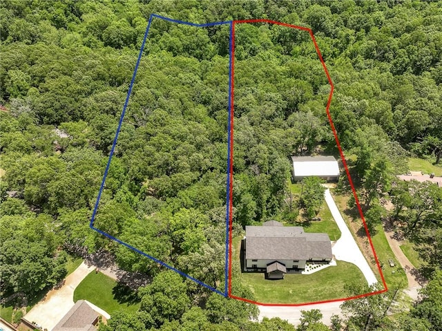 112 E Woodside Ln, Rogers, AR 72756 - aerial overview of property's location featuring a heavily wooded area and property parcel outlined
