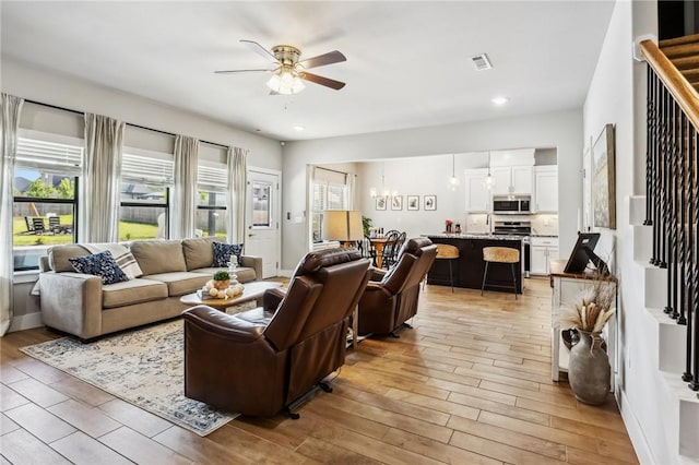201 Ryder St, Gentry, AR 72734 - living area featuring a ceiling fan, a chandelier, light wood-style floors, recessed lighting, and stairway
