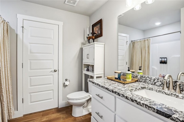 201 Ryder St, Gentry, AR 72734 - bathroom featuring wood finished floors, vanity, toilet, and a shower with curtain