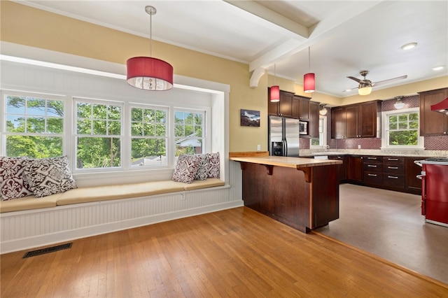 615 E Prairie Creek Dr, Rogers, AR 72756 - kitchen with appliances with stainless steel finishes, light countertops, tasteful backsplash, hardwood / wood-style flooring, and pendant lighting