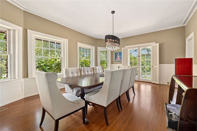615 E Prairie Creek Dr, Rogers, AR 72756 - dining room featuring a chandelier, plenty of natural light, crown molding, dark wood-style floors, and a wainscoted wall