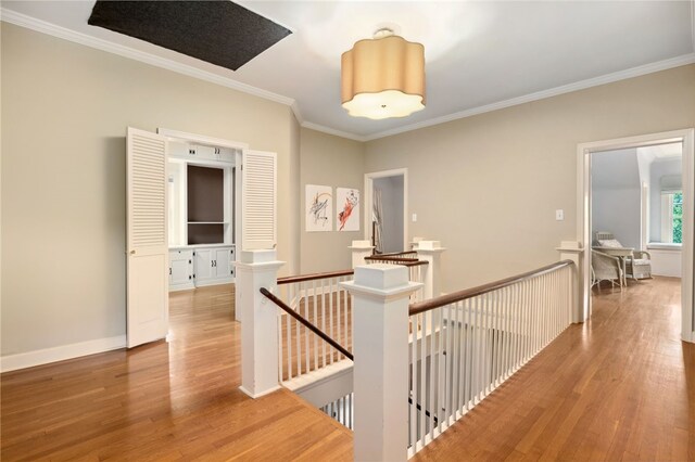 615 E Prairie Creek Dr, Rogers, AR 72756 - hall with an upstairs landing, light wood-type flooring, crown molding, and baseboards