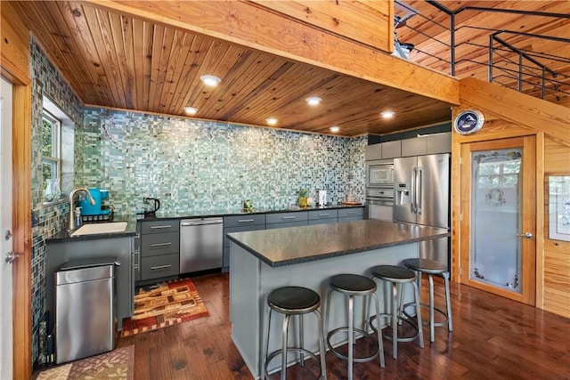 482 County Road 332, Eureka Springs, AR 72632 - kitchen with appliances with stainless steel finishes, dark countertops, a sink, dark wood-style flooring, and wooden ceiling