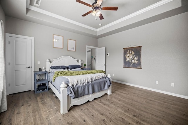 1320 Lariat Dr, Centerton, AR 72719 - bedroom featuring a raised ceiling, wood finished floors, ornamental molding, baseboards, and a ceiling fan