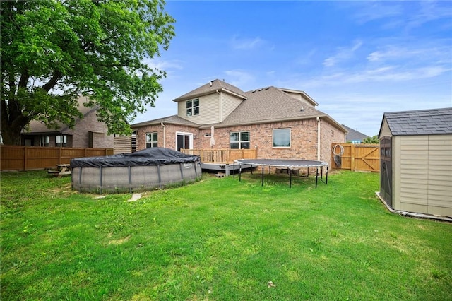 1320 Lariat Dr, Centerton, AR 72719 - back of house with a trampoline and brick siding