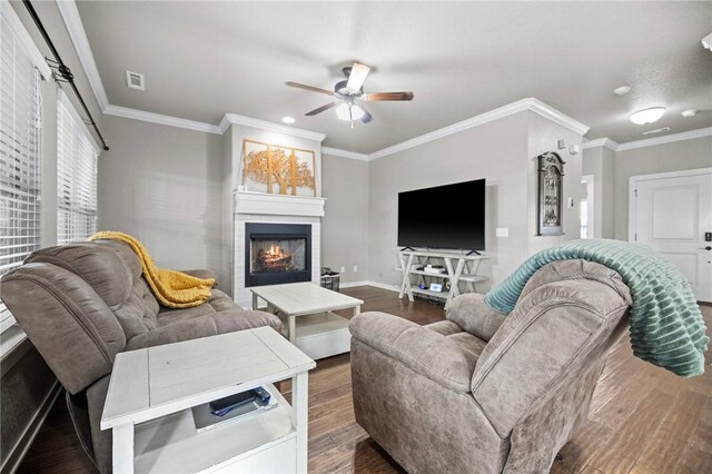 1320 Lariat Dr, Centerton, AR 72719 - living area featuring ceiling fan, wood finished floors, a tiled fireplace, baseboards, and ornamental molding