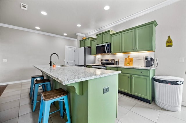 1320 Lariat Dr, Centerton, AR 72719 - kitchen with green cabinetry, appliances with stainless steel finishes, crown molding, a sink, and a breakfast bar area