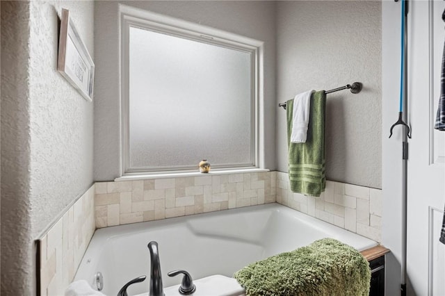 1320 Lariat Dr, Centerton, AR 72719 - bathroom with a tub with jets and a textured wall
