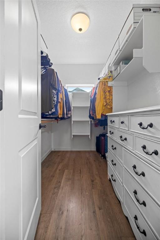 1320 Lariat Dr, Centerton, AR 72719 - walk in closet featuring dark wood finished floors